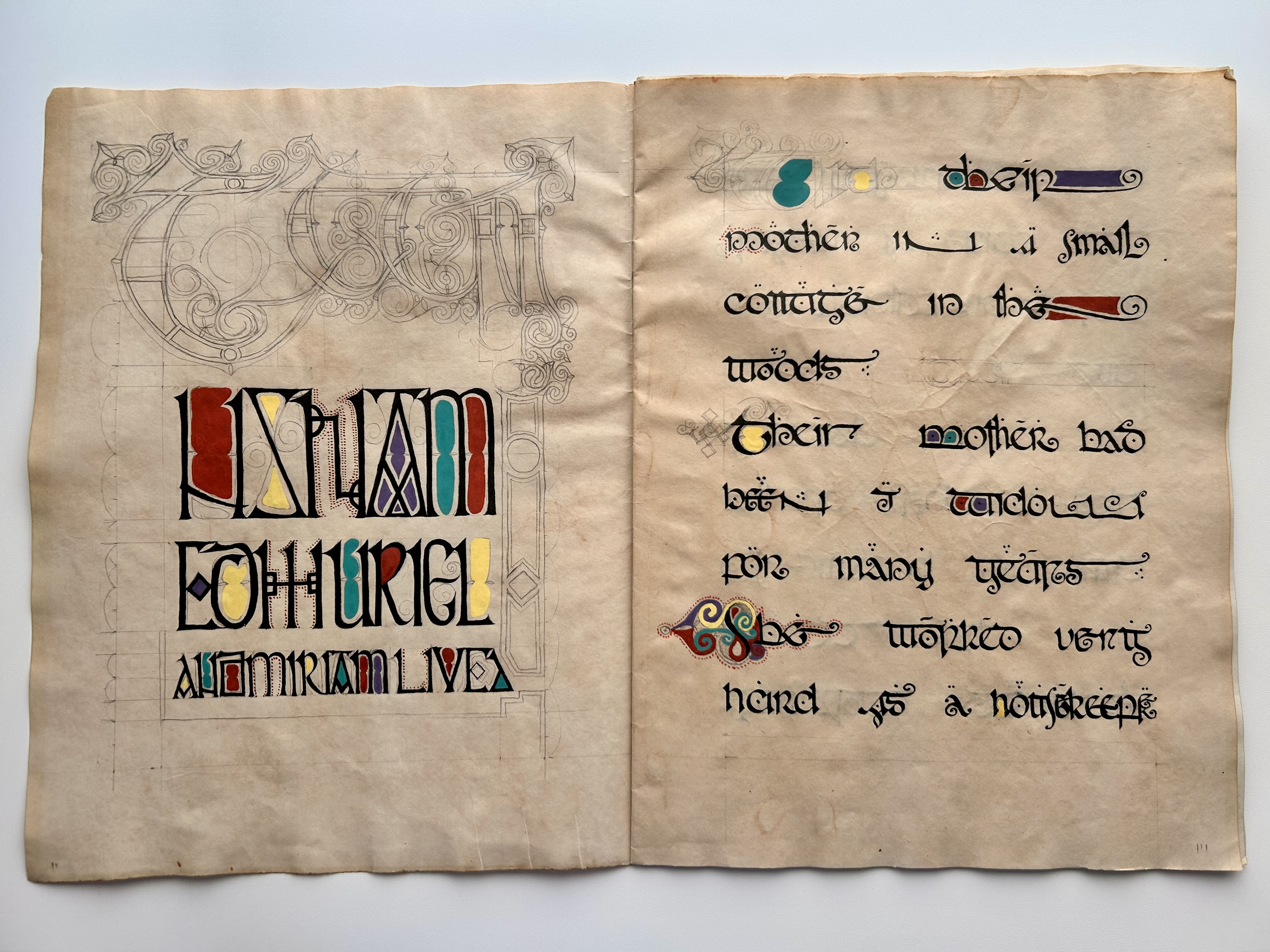 Opening manuscript spread with decorative lettering and calligraphy